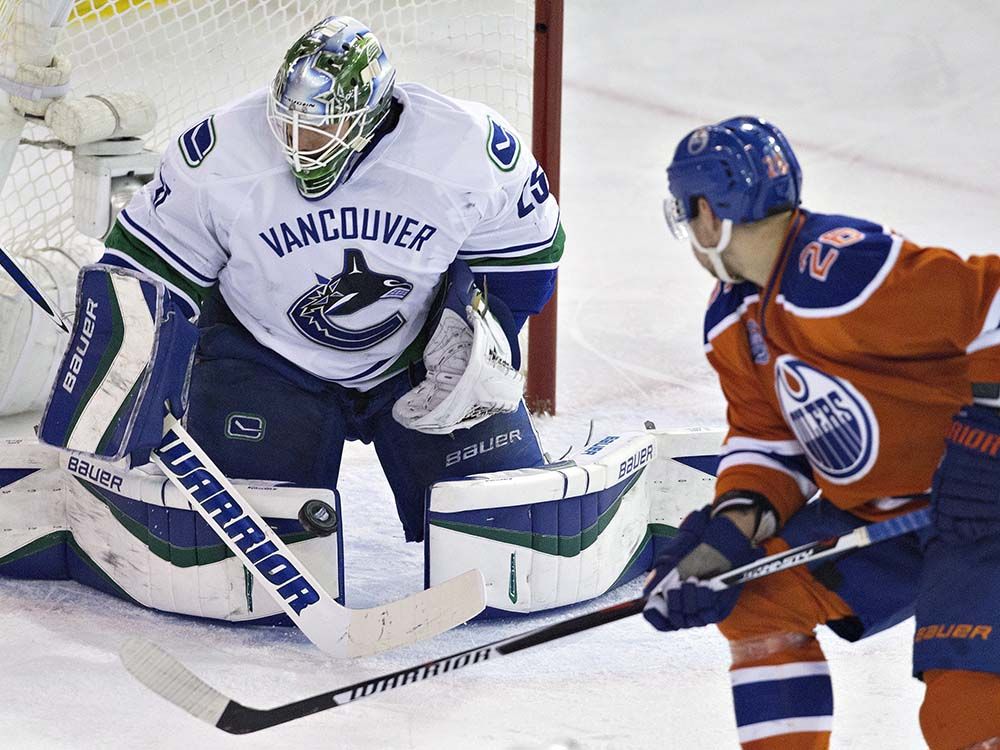Vancouver Canucks goalie Jacob Markstrom (25) makes the save on Edmonton Oilers' Iiro Pakarinen (26) during second period NHL action in Edmonton, Alta., on Wednesday April 6, 2016. THE CANADIAN PRESS/Jason Franson
