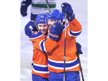 Edmonton Oilers' Jordan Eberle (14) and Patrick Maroon (19) celebrate a goal against the Vancouver Canucks during second period NHL action in Edmonton, Alta., on Wednesday April 6, 2016. THE CANADIAN PRESS/Jason Franson