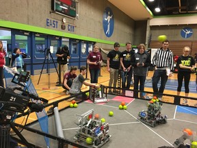 Teagan Parkin, from North Island Distance Education School in Courtenay, controls her team's robot at Saturday's VEX Robotics Competition in Burnaby while teammate Daniel Mailhiot reloads it and Jacob Thornton looks on.