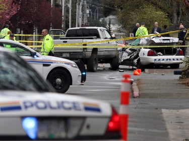 Investigators examine the scene of the crash involving a police car and a pickup truck in Langford, B.C., Tuesday, April 5, 2016. RCMP Const. Sarah Beckett was killed in the crash.