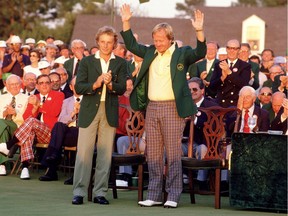 Master(s) of Augusta: Jack Nicklaus raises his arms in triumph after donning one of his six career green jackets after the 1986 Masters Tournament in Augusta, Ga. To the left is the previous year’s champion, Bernhard Langer.