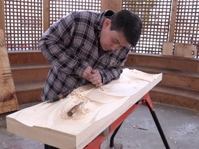 James Harry works on a piece of wood at the Britannia carving pavilion.