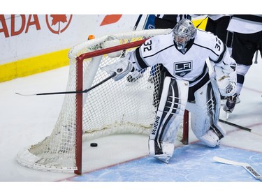 Los Angeles Kings' goalie Jonathan Quick breaks Vancouver Canucks' defenceman Dan Hamhuis' stick on the goal post after he was slashed during the third period of an NHL hockey game in Vancouver, B.C., on Monday April 4, 2016.
