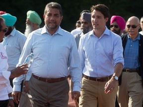 File: Justin Trudeau, right, walks with Sukh Dhaliwal.