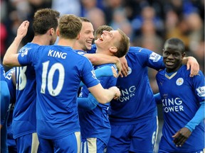Leicester's Marc Albrighton (centre right) celebrates with teammates after scoring against Swansea during their England Premier League soccer match at the King Power Stadium in Leicester, England, last Sunday.
