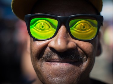 Luis Zamora wears a pair of colourful sunglasses with eyes on them during the annual 4/20 cannabis culture celebration at Sunset Beach in Vancouver, B.C., on Wednesday April 20, 2016.