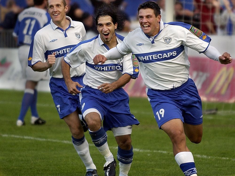 Vancouver-SUN0903-Whitecaps-Vancouver Whitecaps Carlo Corazzin (right), Alfredo Valente (centre) and Martin Nash (left) celebrate after Corazzin scored against Minnesota Thunder in first half of game one of A-League Western Conference semi-final friday night at Swangard Stadium. (Steve Bosch/Vancouver Sun) [PNG Merlin Archive]