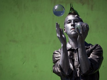 A performer balances glass balls during the annual 4/20 cannabis culture celebration at Sunset Beach in Vancouver, B.C., on Wednesday April 20, 2016.