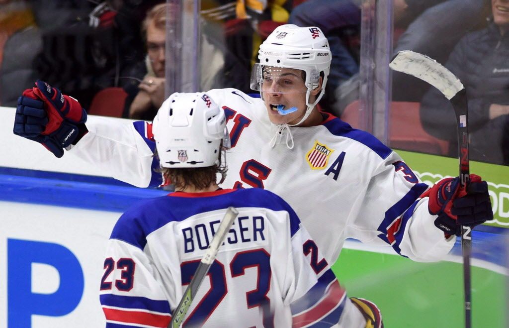 United States' Auston Matthews, back, celebrates a goal with teammate and Canucks prospect Brock Boeser at the IIHF World Junior Championship in Helsinki, Finland, on Saturday, Dec. 26, 2015. 