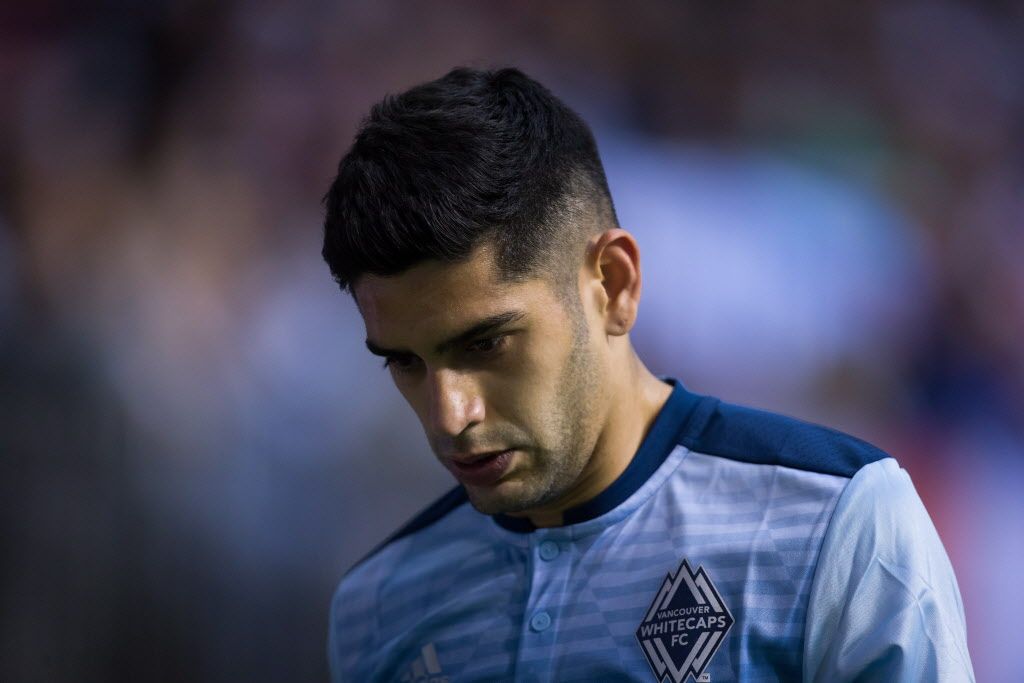 Vancouver Whitecaps' Matias Laba leaves the field after receiving a red card.