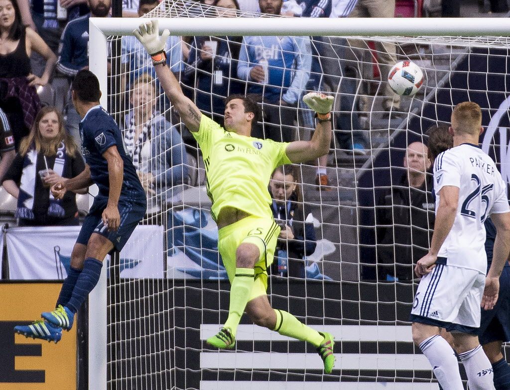 Christian Bolanos scores past Sporting Kansas City goalkeeper Alec Kann (25). 