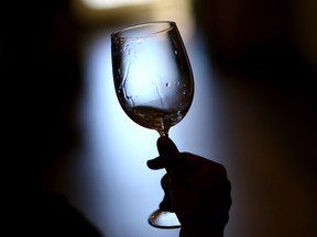 NAPA, CA - AUGUST 26:  A visitor holds a glass of wine while tasting at Madonna Estate Winery on August 26, 2014 in Napa, California.  Two days after a 6.0 magnitude earthquake rocked the Napa Valley, residents and wineries are continuing clean up operations and slowly reopening their doors to customers.