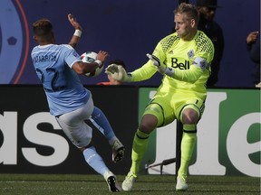 New York City FC defender Ronald Matarrita (22) gets past Vancouver Whitecaps goalkeeper David Ousted (1) but couldn't score during the second half of an MLS soccer game, Saturday, April 30, 2016, in, New York. NYCFC won 3-2.