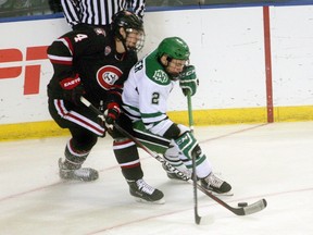 University of North Dakota defenceman Troy Stecher, right, vies for the puck with St. Cloud State’s Ben Storm during an NCAA west regional championship game on March 28, 2015 in Fargo, N.D.