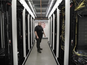 Global Relay COO and co-founder Duff Reid checks over servers at the company's data centre, which is kept cool using an environmentally friendly free-air cooling system.