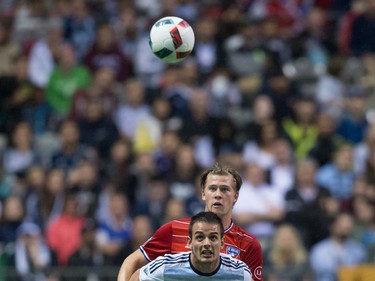 Vancouver Whitecaps' Octavio Rivero, front, and FC Dallas' Walker Zimmerman watch the ball during the first half of an MLS soccer game in Vancouver, B.C., on  April 23, 2016.