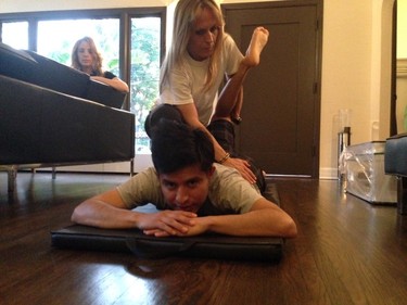 Jockey Mario Gutierrez works on stretching with fitness coach Sabrina Perruzi as his wife Rebecca looks on in their home. He’s now in the top 10 in U.S. jockey rankings.