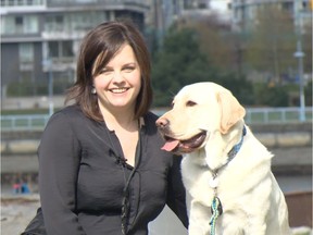 Sue Baker of the Vancouver police victim services unit poses Tuesday with Lucca, the department’s first intervention dog. DAVE RIGLER/PNG