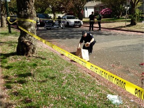 Vancouver Police gather evidence on Heather Street following a fatal hit-and-run early Sunday, near used medical equipment lying on the grass.