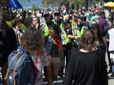 Police officers walk through the crowd during the annual 4/20 cannabis culture celebration at Sunset Beach in Vancouver, B.C., on Wednesday April 20, 2016.
