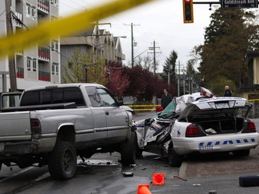 Police tape marks off the scene of the crash involving a police car and a pickup truck in Langford, B.C., Tuesday, April 5, 2016. RCMP Const. Sarah Beckett was killed in the crash.
