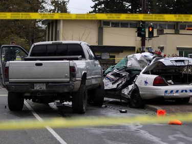Police tape marks off the scene of the crash involving a police car and a pickup truck in Langford, B.C., Tuesday, April 5, 2016. RCMP Const. Sarah Beckett was killed in the crash.