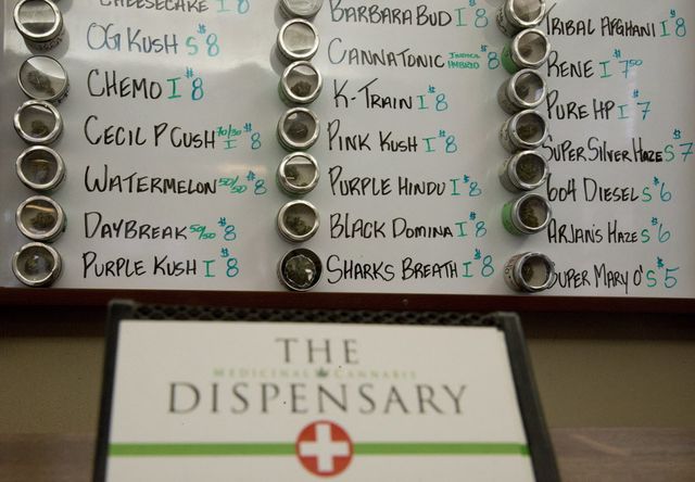 Varieties of marijuana are listed on a board that are available at The Dispensary.