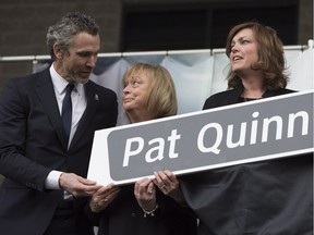 >President of Canucks hockey operations Trevor Linden, left, stands next to Sandra Quinn, wife of Pat Quinn during the dedication ceremony for Pat Quinn Way last year. Kalli Quinn is at right.