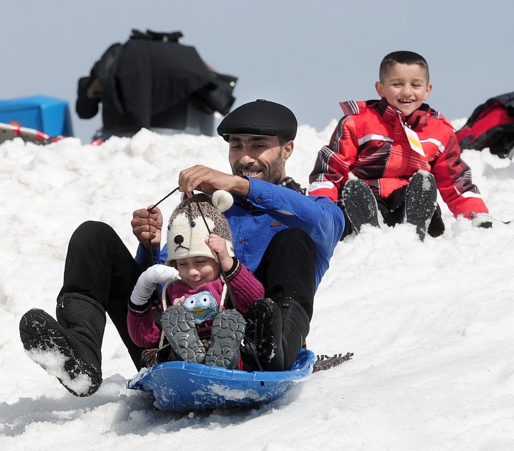 Some of the approximately 350 Syrian refugees enjoy what is for some of them their first snow experience at Mt. Seymour in North Vancouver, BC., April 3, 2016. 