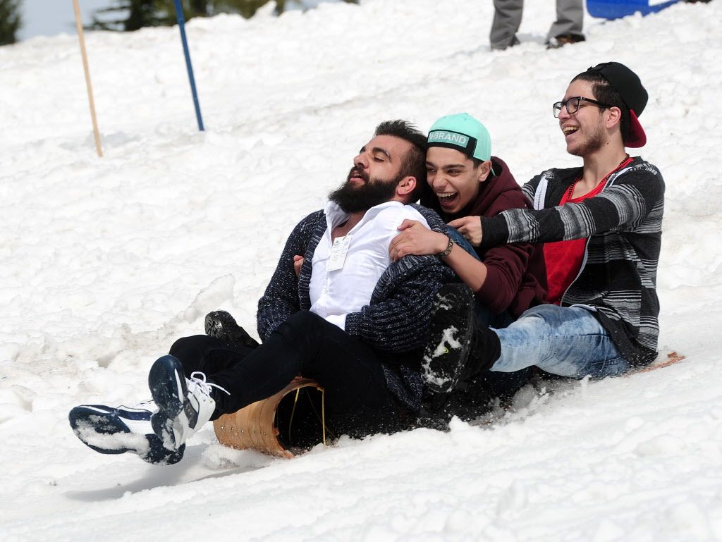 Some of the approximately 350 Syrian refugees enjoy what is for some of them their first snow experience at Mt. Seymour in North Vancouver, BC., April 3, 2016. 