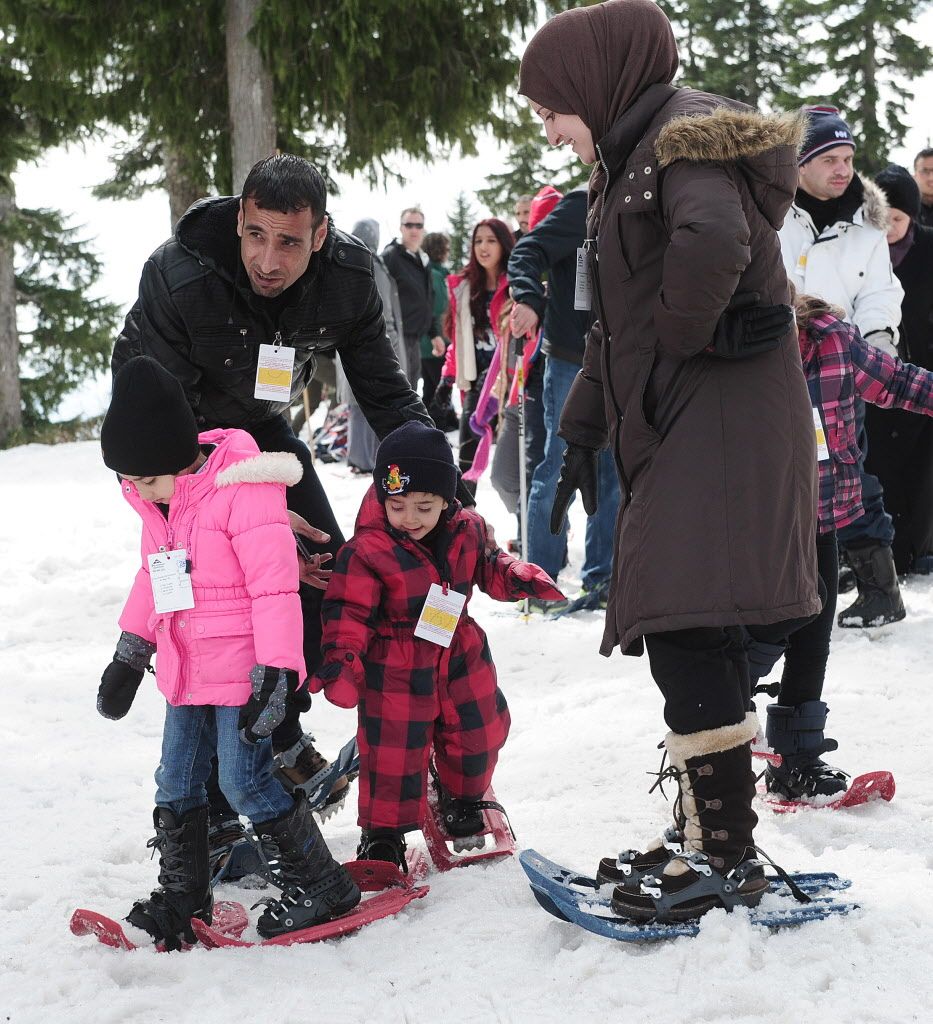Some of the approximately 350 Syrian refugees enjoy what is for some of them their first snow experience at Mt. Seymour in North Vancouver, BC., April 3, 2016. 