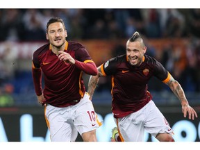 Roma's Francesco Totti, left, celebrates with his teammate Radja Nainggolan after scoring a goal.