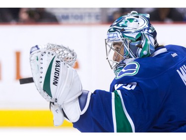 Vancouver Canucks' goalie Ryan Miller makes a glove save against the Los Angeles Kings during the first period of an NHL hockey game in Vancouver, B.C., on Monday April 4, 2016.