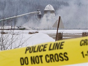 Smoke rises as police tape surrounds Abine Forest Products mill in Burns Lake, B.C. Saturday, Jan. 21, 2012.