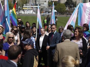NDP MLA Spencer Chandra Herbert, (centre, right), speaks to transgender supporters following a bill announcement which will be introduced to the house to support transgender rights in Victoria, B.C., Wednesday, April 27, 2016.