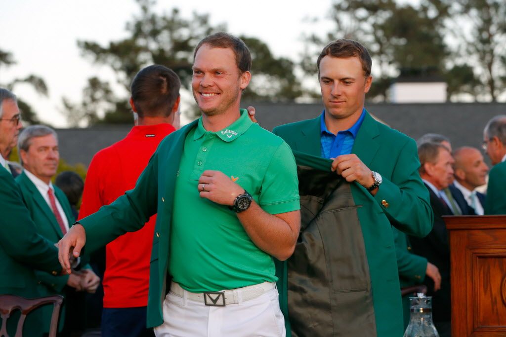  Jordan Spieth of the United States presents Danny Willett of England with the green jacket after Willett won the final round of the 2016 Masters Tournament. 