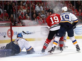 Jonathan Toews of the Chicago Blackhawks watches as the puck slips past St. Louis Blues goalie Brian Elliott on a goal by Trevor van Riemsdyk Saturday in Chicago. The Hawks were down 3-1 but won 6-3.