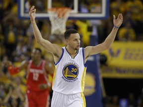 Golden State Warriors star Stephen Curry celebrates after scoring against the Houston Rockets during the first half in Game 1 of their first-round NBA playoff series on Saturday in Oakland, Calif. Curry put up 24 points to lead the heavily favoured Warriors to a 104-78 win over the Houston Rockets.