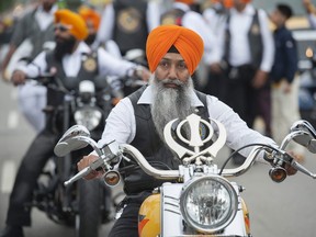 A member of the Sikh Motorcycle Club rides in the annual Vaisakhi parade in Surrey on Saturday, April 23, 2016.
