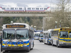 SkyTrain travels past several Coast Mountain buses at the Surrey Central Exchange as part of Translink infrastructure in Surrey, B.C. Thursday March 12, 2015.