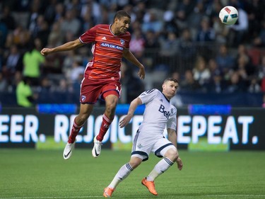 FC Dallas' Tesho Akindele, left, heads the ball past Vancouver Whitecaps' Fraser Aird during the first half of an MLS soccer game in Vancouver, B.C., on April 23, 2016.