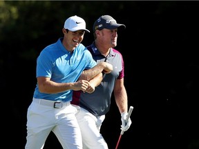Rory McIlroy, left, and Jamie Donaldson lock arms during a practice round on Tuesday, prior to Thursday’s start of the 2016 Masters Tournament at Augusta National Golf Club in Augusta, Ga.
