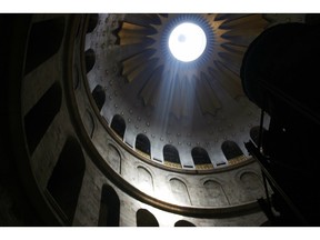 The mid-day sun shines angelically into the Church of the Holy Sepulchre. First constructed in the 4th Century, the church sits on the spot where Christians believe Jesus was crucified, and inside, the tomb in which he was buried. Ken Donohue