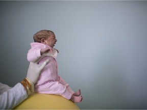 This Feb. 12, 2016 photo shows two-week-old Sophia, born with microcephaly, during a physical therapy session at the Pedro I hospital in Campina Grande, Brazil.