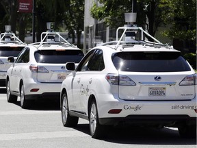 This May 13, 2014 file photo shows a row of Google self-driving Lexus cars at a Google event outside the Computer History Museum in Mountain View, Calif.
