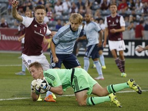 Sporting KC goalkeeper Tim Melia, front, will be looking to outduel the Dane — Vancouver's David Ousted — when the two teams meet Wednesday night at B.C. Place.