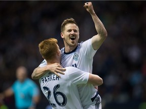 Vancouver Whitecaps' Jordan Harvey, right, and Tim Parker celebrate Harvey's goal against FC Dallas during the second half in Vancouver, B.C., on April 23, 2016.