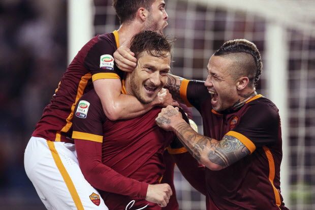 Roma's Francesco Totti, center, celebrates with his teammates after scoring the winning goal during a Serie A soccer match between Roma and Torino at Rome's Olympic stadium on April 20, 2016.