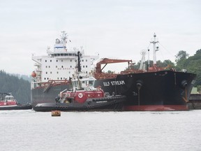 Tugs assist a tanker at the Kinder Morgan Trans Mountain terminal in Burnaby.