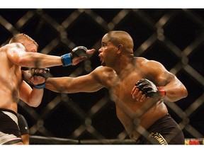 UFC light heavyweight champion Daniel Cormier, right, throws a punch at Alexander Gustafsson during a mixed martial arts battle last October. Cormier was forced to withdraw from a fight for the first time in his professional career.